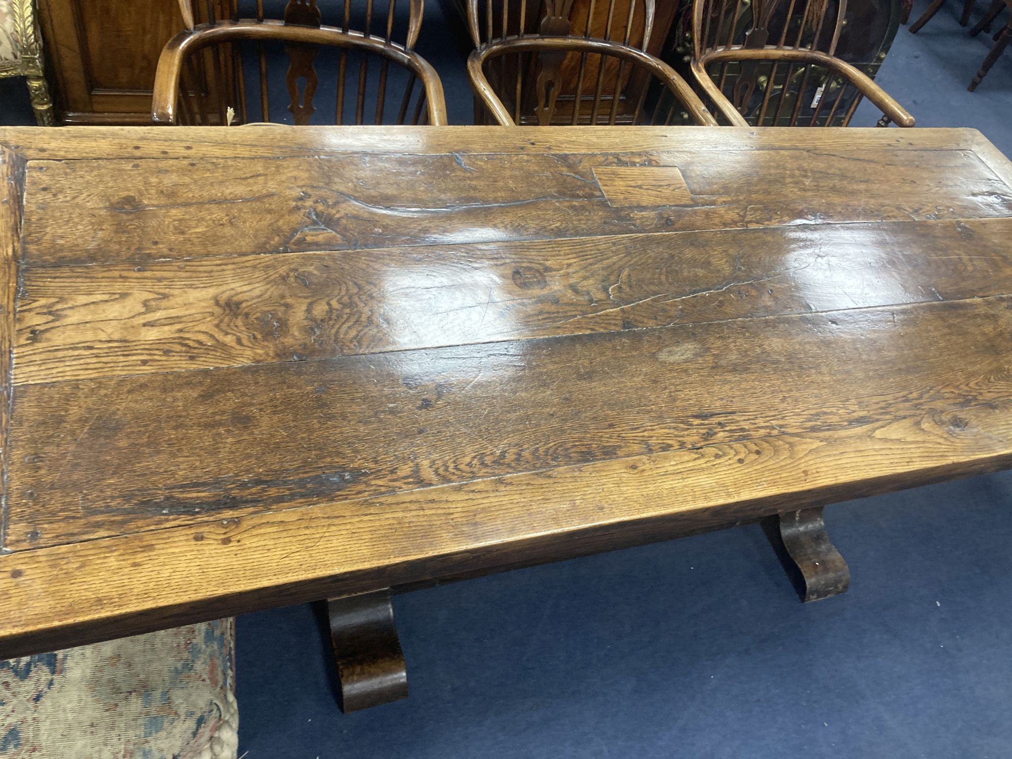 An oak refectory table, the top (formerly a door), length 209cm, depth 85cm, height 73cm